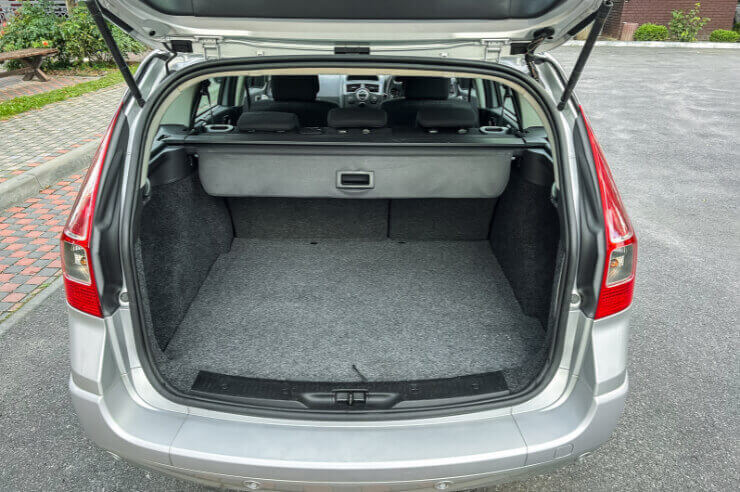 Rear view of silver car, the boot door is open and the boot appears empty