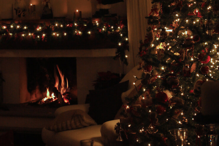 Christmas tree Living room with a lit fire and decorated Christmas tree