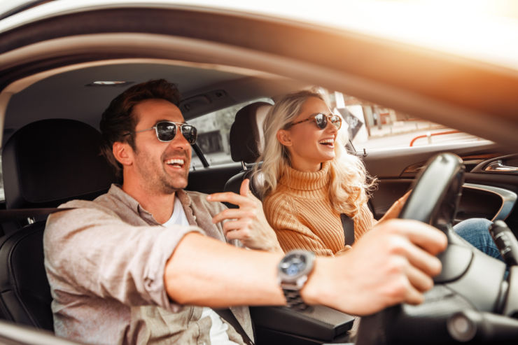 Smiling couple driving car - Travel insurance from An Post Insurance