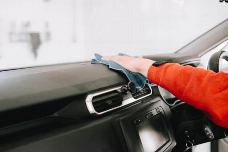 Internal view of car being dusted with cloth