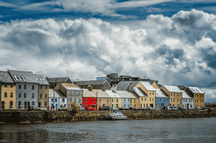 Long row of brightly coloured houses along the River Suir in county Waterford, Ireland