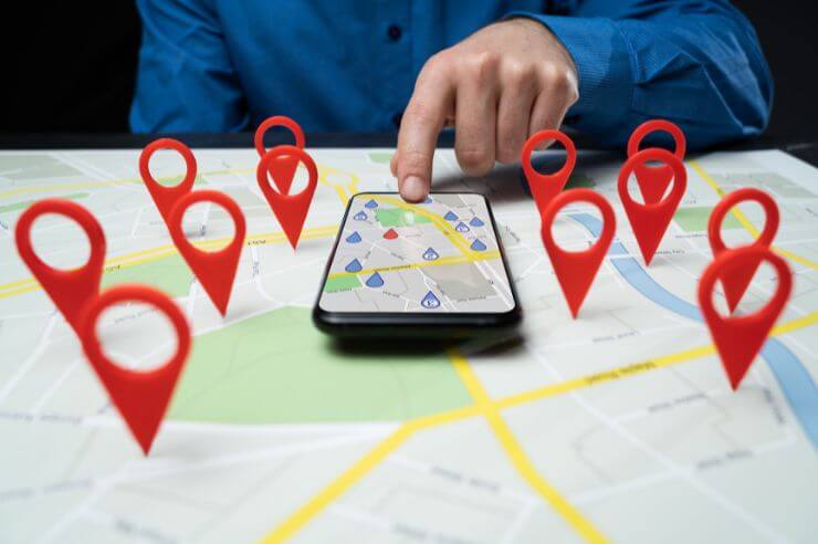 Google Maps Person using navigation app with map pins on a smartphone