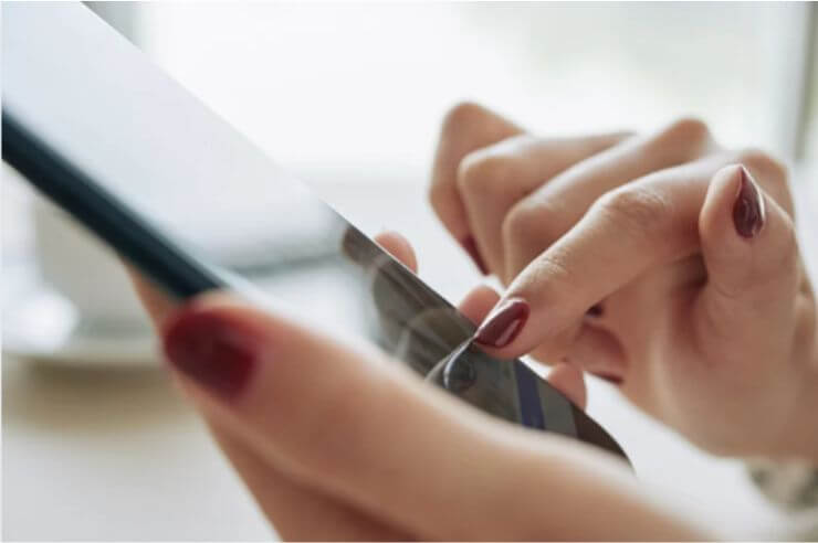 hand holding mobile phone Woman’s hands holding mobile phone