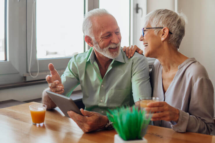Happy Couple Older couple planning a will using a tablet | An Post Insurance