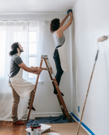 Couple painting living room | To-Dos for New Homeowners | An Post Insurance