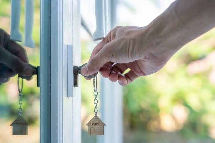 Key in door with small house keychain