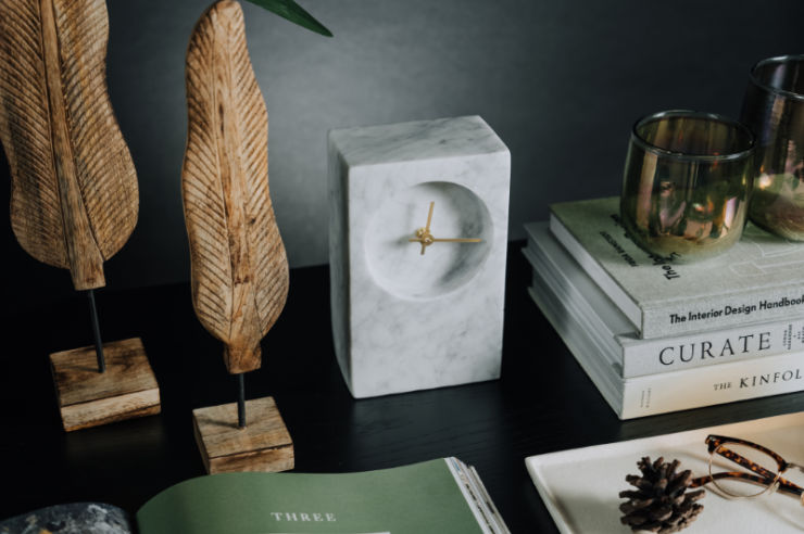 Clock, books and ornaments on dark table | Interior Trends 2024 | An Post Insurance