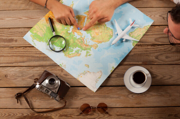 Colourful map of the world with a magnifying glass resting on top
