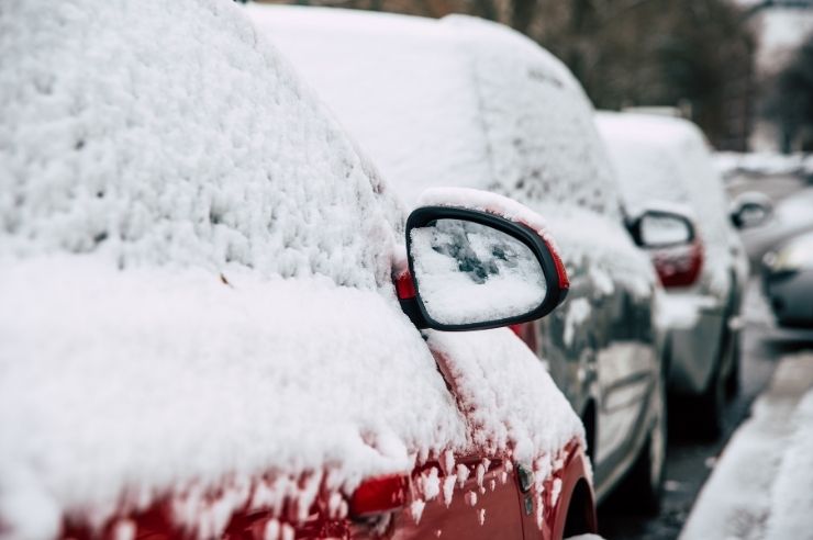Parked cars covered in snow Row of parked cards covered in snow