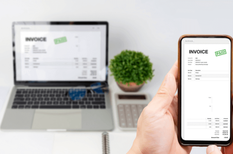 Invoice that has been marked as paid displayed on laptop and mobile phone