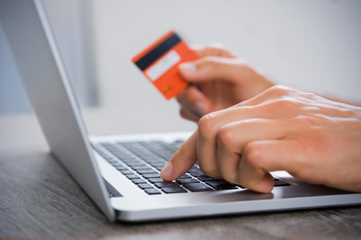 Paying online Person managing documents digitally on laptop