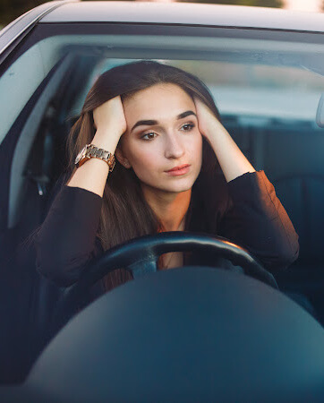 Frustrated Lady stuck in traffic in her car