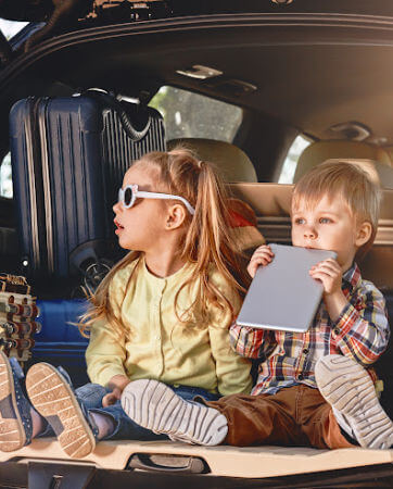 Kids sitting in the back of a packed SUV