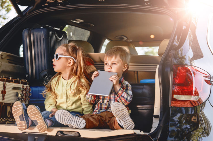 Kids sitting in the back of a packed SUV