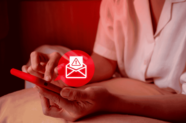 Woman holding smartphone, red icon above indicates a suspicious email has been received 
