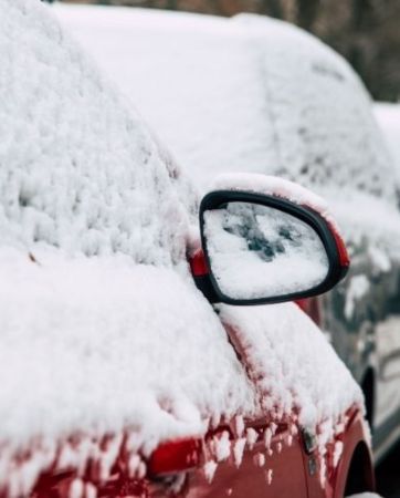 Row of parked cards covered in snow