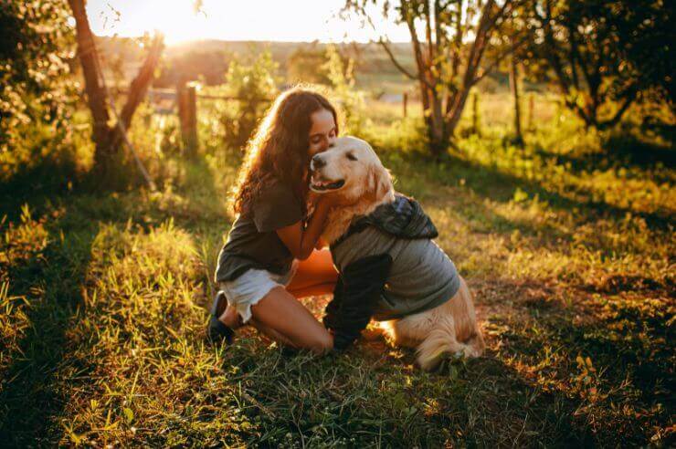 Young girl with her golden retriever Woman and her Golden Retriever in forest | An Post Insurance
