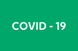 Green background with white text reading 'COVID-19' in bold capital letters.