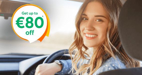 Smiling woman sitting in the driver’s seat of a car with text overlay “Get up to €60 off”, promoting car insurance savings in Ireland.