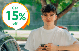 Young male driver smiling beside a car outdoors, with text “get 15% off” promoting affordable car insurance for younger drivers in Ireland
