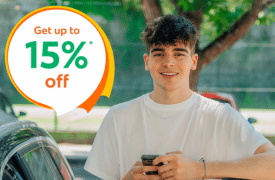 Young male driver smiling beside a car outdoors, with text “get 15% off” promoting affordable car insurance for younger drivers in Ireland